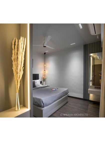 A glimpse into the master bedroom at Tulsi Heights. The warm lighting and soft textures create an inviting and cozy atmosphere, perfect for a good night's sleep.