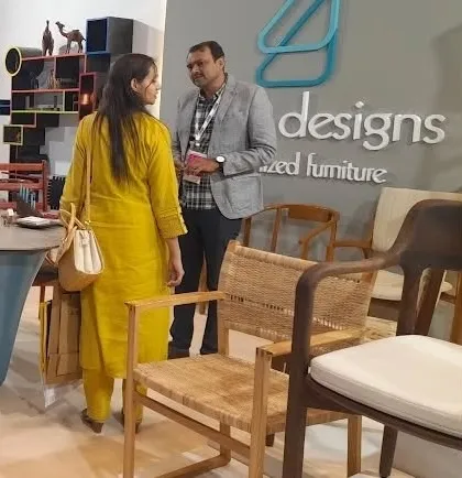 A visitor examining the craftsmanship of a woven armchair, one of the many designs we had on display.