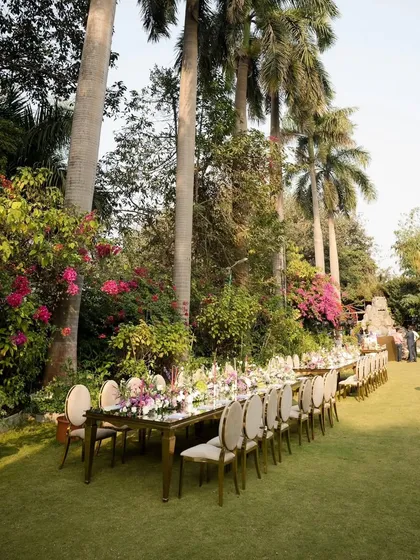 This wide shot shows the scale of the outdoor dining arrangement. The table is perfectly integrated into the natural landscape, creating an immersive experience for guests.