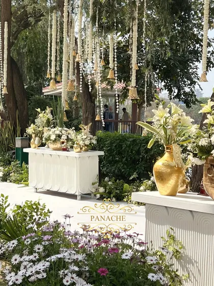 The welcome area, with multiple consoles and hanging floral decorations, creating a beautiful and immersive entrance for guests.