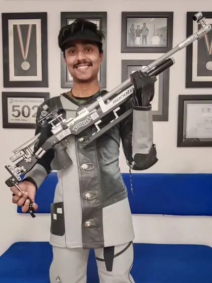 Tahzeeb Khan proudly displays his Walther rifle after becoming a "Renowned Shot" at the 67th National Shooting Championship. His discipline and tireless effort have set him apart.