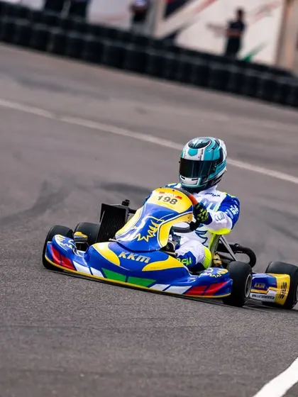Our driver in the KKM-liveried kart, focused on the track ahead during a competitive session.