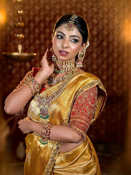 A portrait of the golden Muhurtham bride, highlighting the intricate jewelry and flawless makeup.