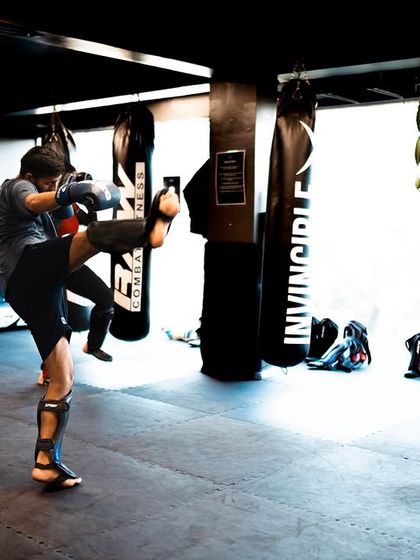 A look at a typical striking class in session. Students are practicing their high kicks, building both flexibility and power.