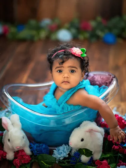 Our little miss sunshine surrounded by her bunny friends and colorful flowers. This setup is a cheerful and sweet option for a sitter session.
