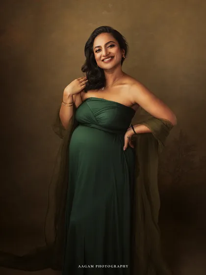 A portrait that glows with happiness. The soft lighting and her warm smile make this a truly joyful and timeless image of impending motherhood.