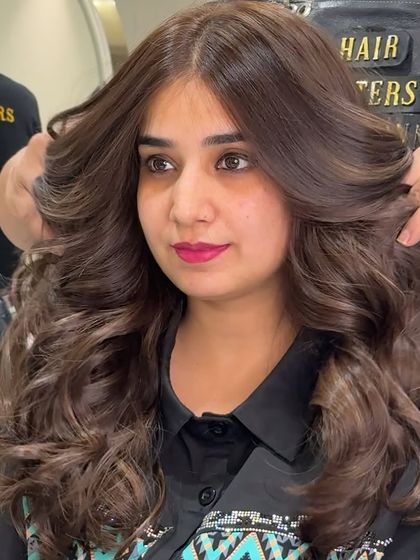 A side view of the beautiful mocha brown no bleach color. You can see the incredible volume and how the layers are styled away from the face to create a soft, open look.