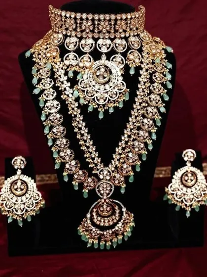 Here is a full view of one of my most requested bridal sets for rent. This magnificent Polki set features a wide choker, a matching long rani haar, and heavy chandbali earrings, all detailed with delicate mint green beads for a regal finish.