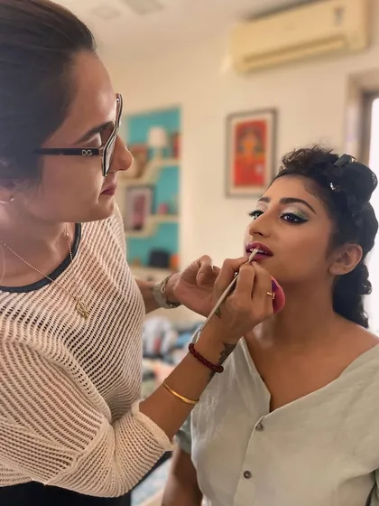 A behind-the-scenes moment where I am carefully applying lipstick for an engagement bride. This shows the precision and personal attention I dedicate to every client, ensuring each detail is perfect for their big day.