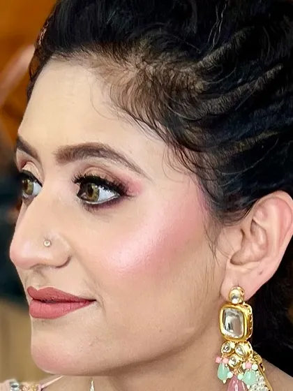 The secret to beautiful makeup is a flawless base. This close-up profile shot shows our expertise in creating smooth, radiant skin, perfectly blended eyeshadow, and defined brows for a polished and elegant party look.