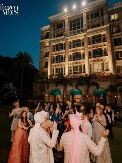 A wide shot of the baraat, showing everyone dancing together. This captures the scale of the celebration and the collective joy of the moment.