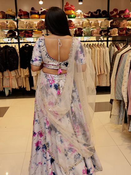 The back of the tie-dye lehenga features a simple and elegant tie-up tassel, adding a final touch to this beautiful and modern rental piece.
