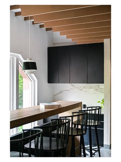 We used a black and white palette for the pantry cabinetry, adding warmth with the wood dining counter. The space is designed to be a pleasant spot for employees to take a break.