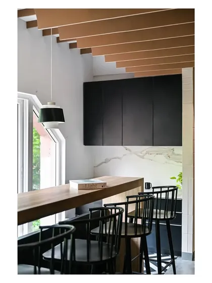 We used a black and white palette for the pantry cabinetry, adding warmth with the wood dining counter. The space is designed to be a pleasant spot for employees to take a break.
