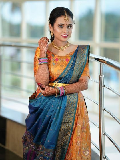 A smiling portrait of Yoshitha, showing off her colorful outfit and the subtle yet glowing makeup look.