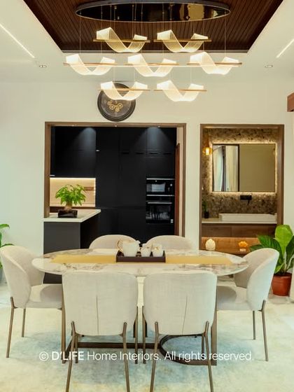 This dining area combines intricate traditional woodwork with a modern chandelier and dining set, showcasing my ability to blend different styles into a cohesive and luxurious space.