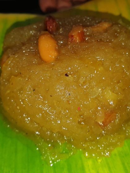 A scoop of our warm and delicious Kesari Bath, glistening with ghee and studded with nuts. A perfect end to any meal.