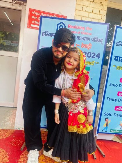 A proud moment with my student Navya after her win at the Bal Mahotsav. We train our students for state and national level folk dance competitions.