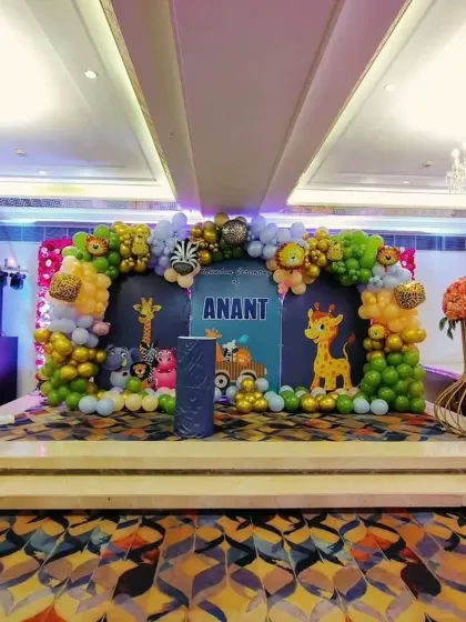 The main stage for Anant's jungle-themed mundan ceremony. I designed a large backdrop with animal cutouts and a full organic balloon arch to create an immersive experience.