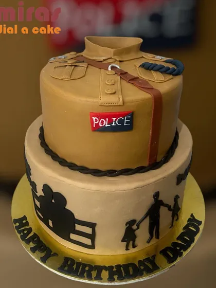 This cake is a heartfelt tribute to a real-life hero. I designed this two-tier cake to look like a police uniform, with personal touches like family silhouettes on the bottom tier to celebrate a husband, father, and grandpa on his birthday.