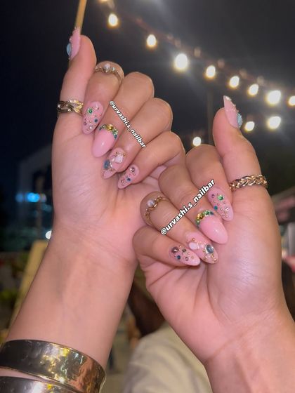 For a full Bollywood dream look, I created these blush-pink nails adorned with colorful jewels and gold accents. They catch the light beautifully and have that main-character energy perfect for a sangeet or reception.