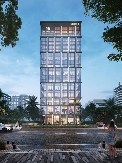 The full view of the "Pramukh Orbit-4" commercial tower in Surat. Its minimalist, glass-heavy design is intended to be a structural gem that reflects the city's identity as a global diamond hub.