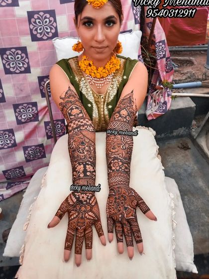 A bride adorned with floral jewelry and our intricate mehndi, looking absolutely radiant.