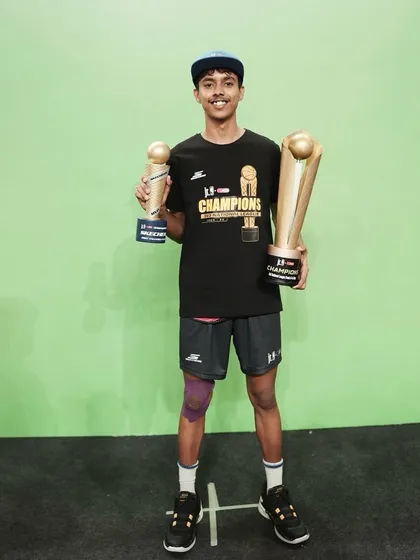 To be a champion, you have to believe in yourself. This young player holding his trophies is a perfect example of that mindset.