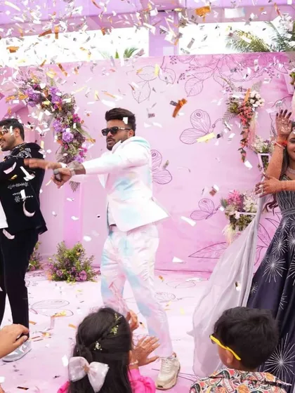 A candid shot of the anchor and the couple dancing amidst a shower of confetti at the carnival. It's all about non-stop entertainment.