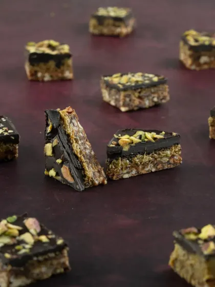 Experience the unique texture of our crunchy Kunafa specialties. This close-up shows the layers of our Kunafa Crunch, a perfect bite-sized treat for Diwali.