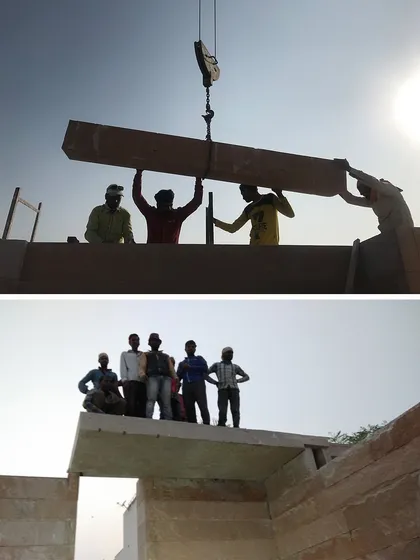 Workers silhouetted against the sun while placing a stone beam. This image celebrates the human effort and pride involved in this ambitious construction project.
