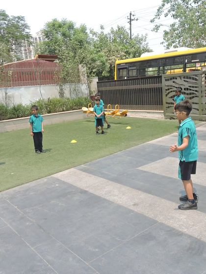 Teamwork in action as students participate in a game of dodgeball in the school's outdoor area.