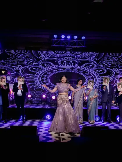 A creative family act using face masks of the couple. This is a great example of how we personalize performances with fun, unique ideas.