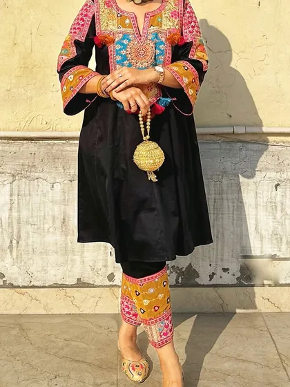 A closer view of the golden potli, showing the craftsmanship of the woven base and the beaded handle. It’s a small detail that makes a big impact.