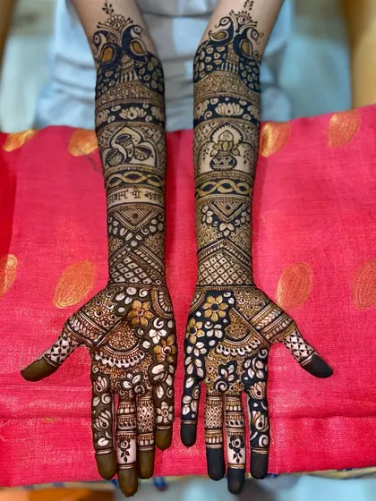 A beautiful floral and peacock design, with delicate flowers on the palms and graceful peacocks on the arms.