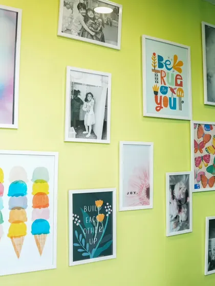 Our Wall of Joy! This wall is filled with happy pictures and art, reflecting the cheerful atmosphere of our play cafe.