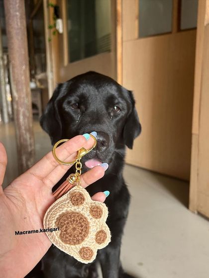 My dog giving his sniff of approval to our paw print keychain. It’s a heartfelt creation from one dog lover to another.