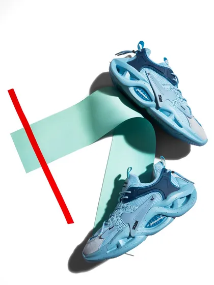 A vibrant and graphic composition for a pair of light blue sneakers. The use of colored paper and a bold red line creates a playful, pop-art feel that is perfect for social media.