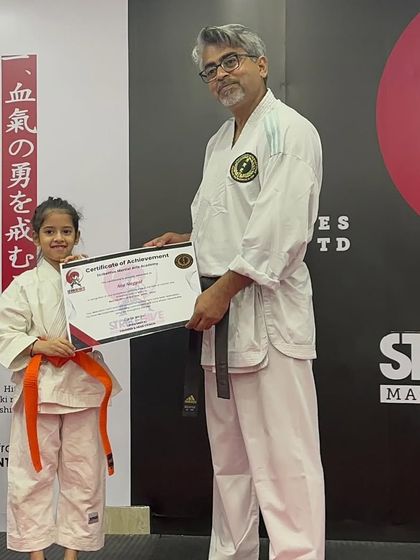 A young student receives the "Best Student" award, recognizing her exceptional performance and exponential growth over the year.