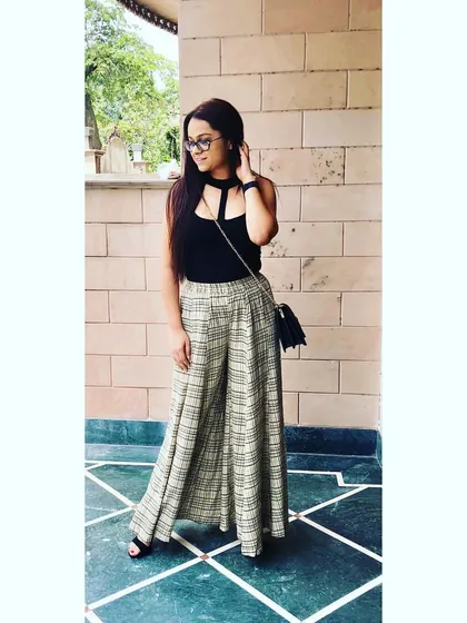 When work calls, I answer in style. A sleek black bodysuit paired with flowy palazzo pants is a comfortable yet professional outfit, perfect for client meetings or a day at the office.