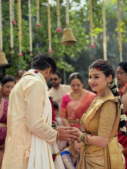 A beautiful moment from the wedding ceremony. The bride's side profile shows off her intricate hairstyle and the soft, radiant finish of her makeup.