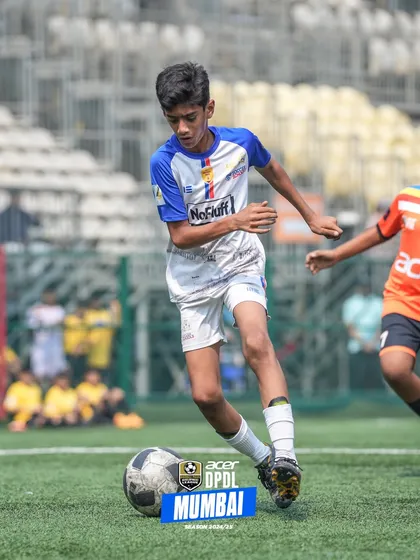 A player dribbling past a defender at our Cooperage ground.