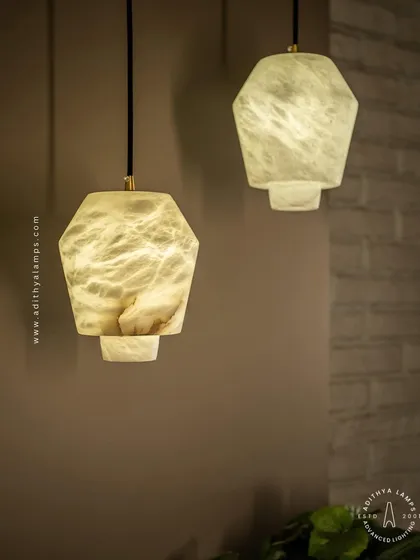 Crafted from natural marble, these hexagonal pendant lights offer a unique, organic beauty. When lit, the stone's natural veining is revealed, creating a warm and subtle glow perfect for kitchens or intimate dining settings.