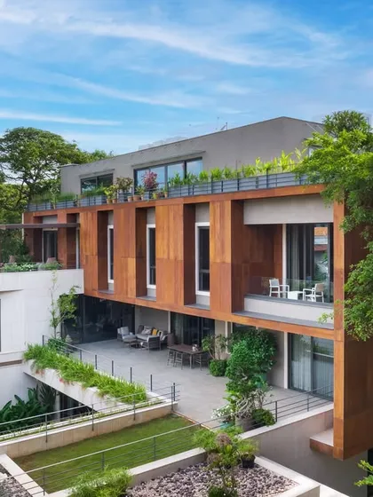 The U-L-I Residence, a 25,000 sq. ft. multigenerational home in Bangalore, is designed to exist in harmony with its lush surroundings. The structure integrates private decks and interconnected courtyards, creating a sanctuary that balances family connection with individual privacy.
