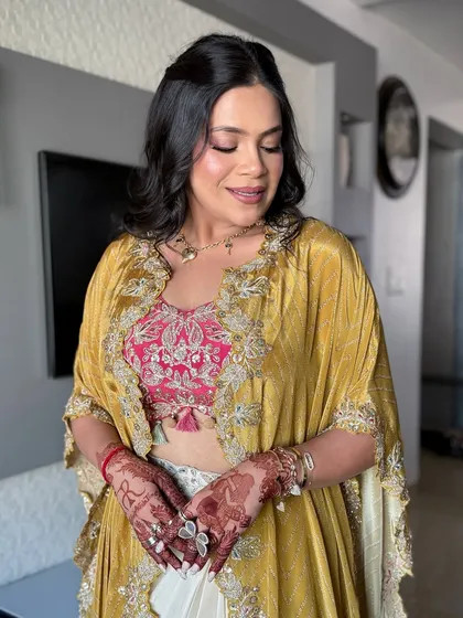 A full view of the look, showing the stylish outfit and the beautiful makeup.