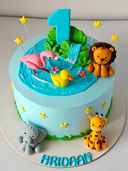 The final, beautiful jungle animal cake, brought to life from an AI image. The details, from the waterfall to the cute animal expressions, were all carefully replicated.