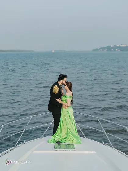 An intimate and cinematic moment on the bow of a yacht in Goa. The vast sea behind them and the tender embrace create a feeling of being in their own world.