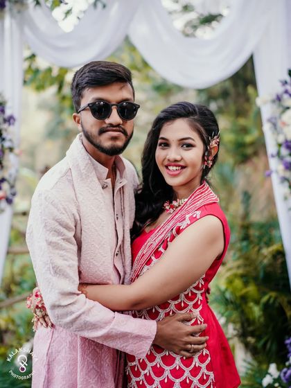 A lovely portrait of the couple, with the groom in sunglasses, at their Haldi event.