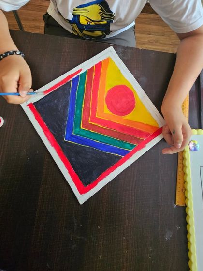 It’s amazing to see students recreate works by the masters! This student is painting a vibrant abstract piece inspired by the artist S.H. Raza during one of our special artist workshops.