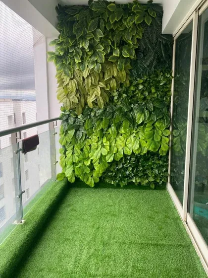 Even a small apartment balcony can become a green oasis. This project features a full-height artificial green wall and matching artificial turf, creating a private, zero-maintenance retreat.
